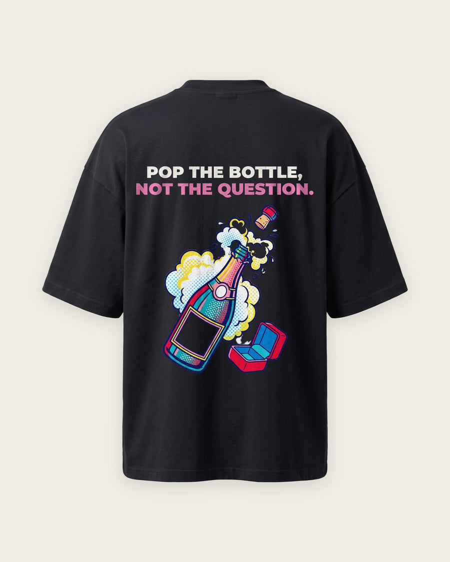 Camiseta Oversized “Pop the Bottle, Not the Question”