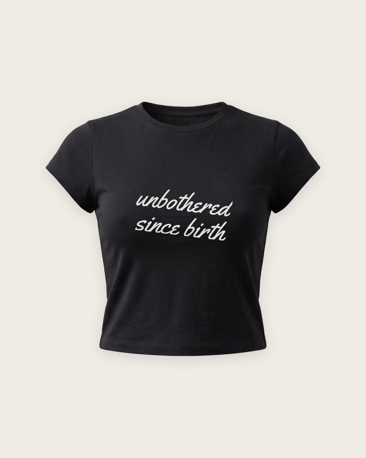 Baby Tee “Unbothered Since Birth” — Preto
